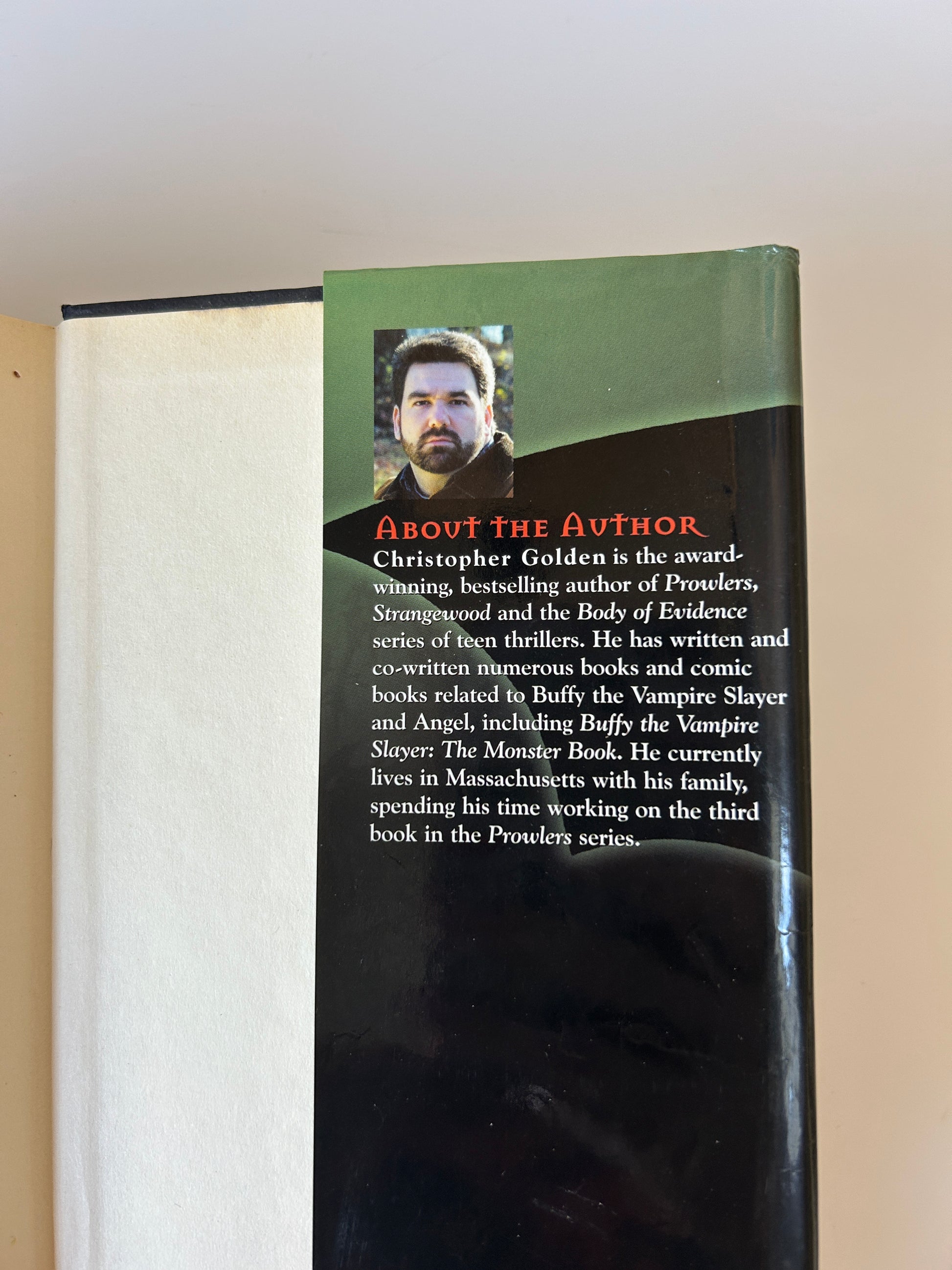 Book with a green section about the author on a white background